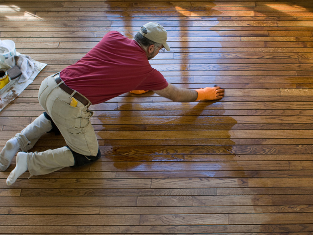 a trenton floor refinisher hard at work updating a wood floor.